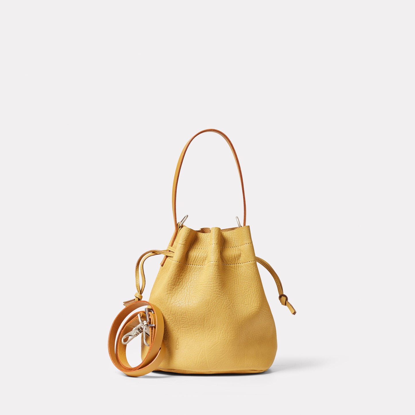 Dora Small Calvert Leather Crossbody Bucket Bag in Dijon