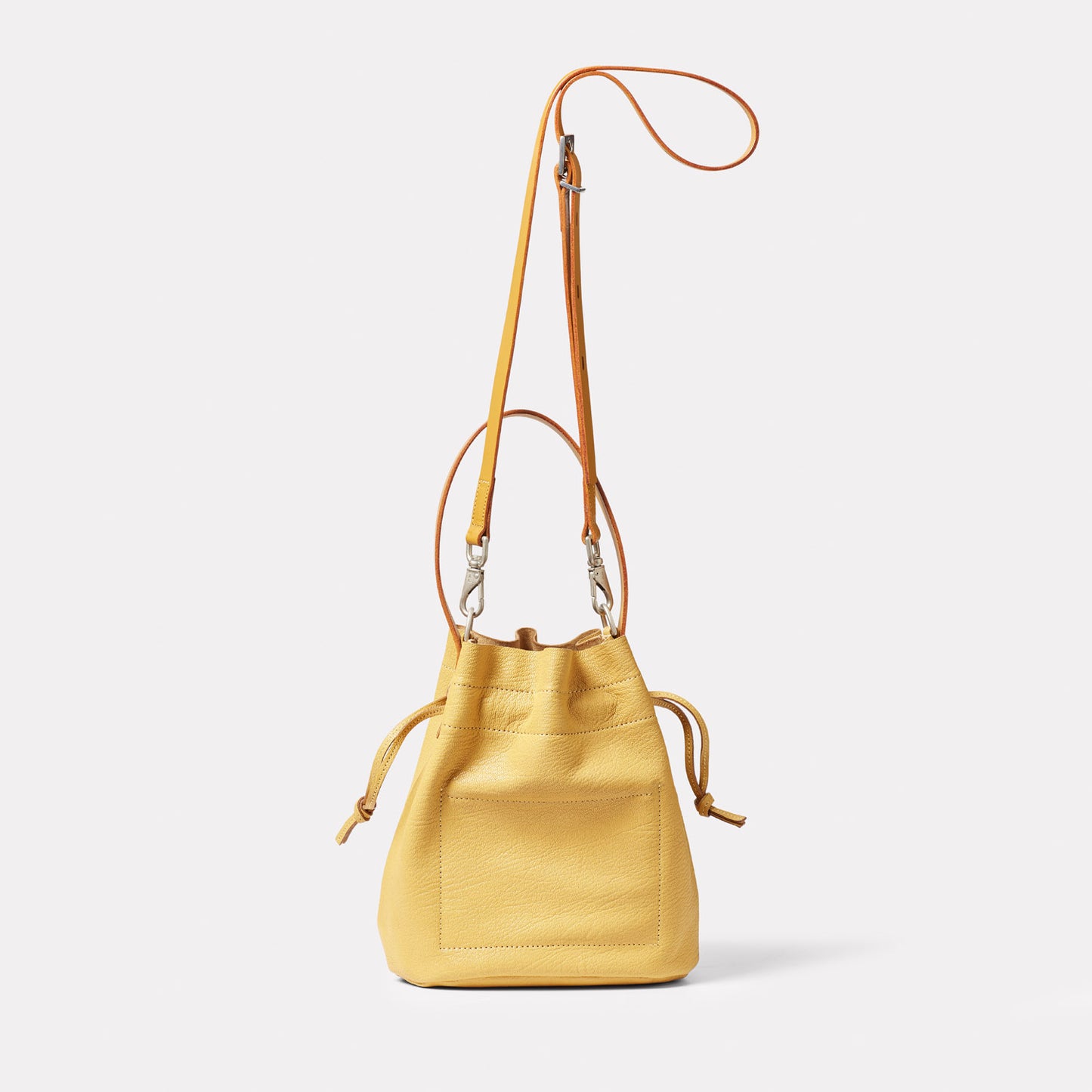 Dora Small Calvert Leather Crossbody Bucket Bag in Dijon