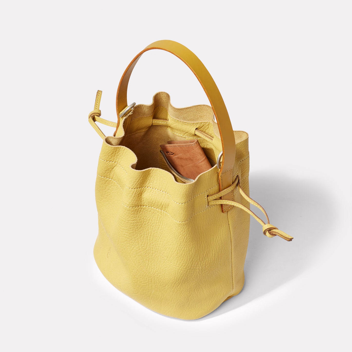 Dora Small Calvert Leather Crossbody Bucket Bag in Dijon