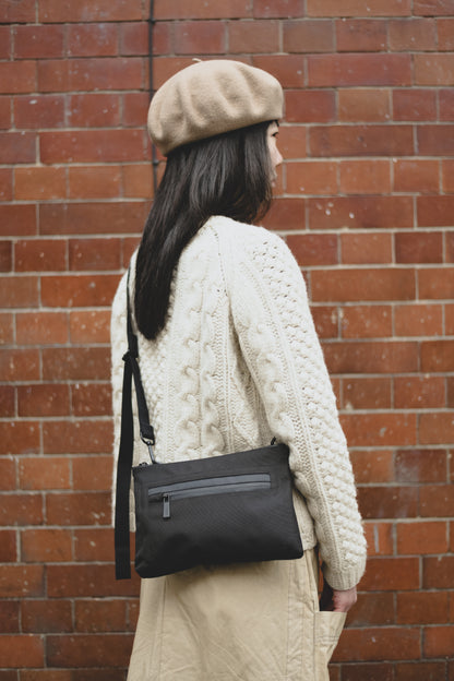 Herb Travel Cycle Crossbody Bag in Black